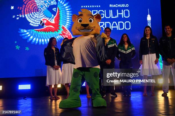 Ginga, mascot of the Brazilian Olympic Team, accompanied by Brazilian athletes, gestures during the presentation of the Brazilian Olympic Team...