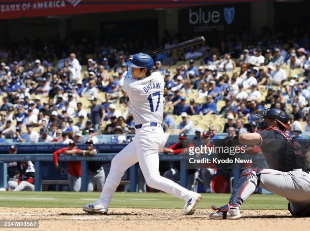 Shohei Ohtani of the Los Angeles Dodgers hits a single in the eighth inning of a baseball game against the Washington Nationals on April 17 at Dodger...