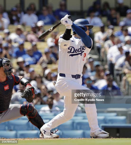 Shohei Ohtani of the Los Angeles Dodgers hits a single in the eighth inning of a baseball game against the Washington Nationals on April 17 at Dodger...