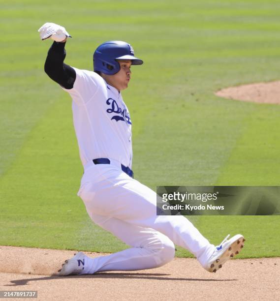 Shohei Ohtani of the Los Angeles Dodgers steals second base in the eighth inning of a baseball game against the Washington Nationals on April 17 at...