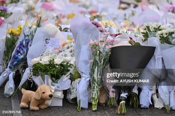 Members of the community visit the flower memorial on Oxford Street near the Bondi Junction Westfield shopping centre to pay their respects to the...