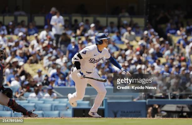 Shohei Ohtani of the Los Angeles Dodgers hits a single in the sixth inning of a baseball game against the Washington Nationals on April 17 at Dodger...