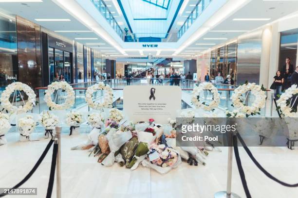 Flowers are left at the memorial in the Westfield Bondi Junction shopping centre during a day of reflection on April 18, 2024 in Bondi Junction,...