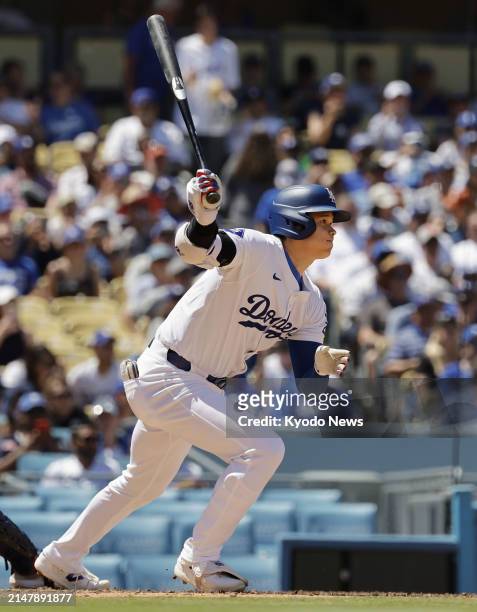 Shohei Ohtani of the Los Angeles Dodgers hits a single in the sixth inning of a baseball game against the Washington Nationals on April 17 at Dodger...