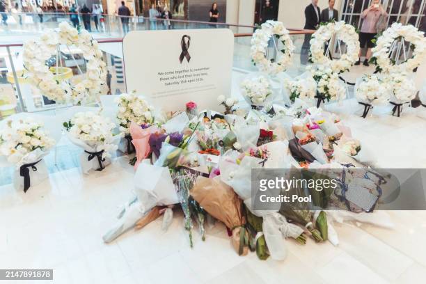 Flowers are left at the memorial in the Westfield Bondi Junction shopping centre during a day of reflection on April 18, 2024 in Bondi Junction,...