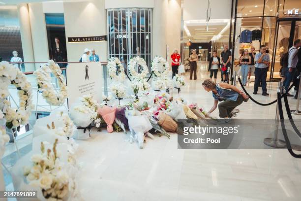 Members of the public visit the memorial at the Westfield Bondi Junction shopping centre during a day of reflection on April 18, 2024 in Bondi...