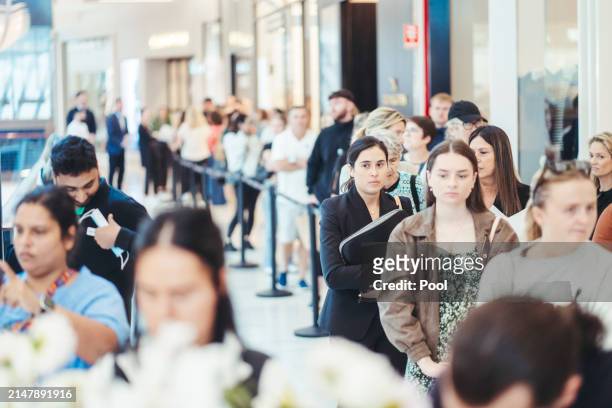 Members of the public line up to visit the memorial at the Westfield Bondi Junction shopping centre during a day of reflection on April 18, 2024 in...