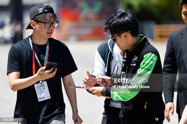 Zhou Guanyu, Stake F1 Team Kick Sauber, signs autographs for fans during previews ahead of the F1 Grand Prix of China at Shanghai International...