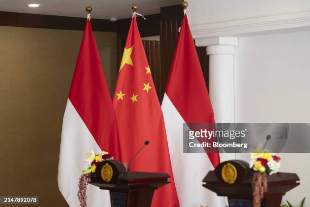 Chinese national flag and Indonesian national flags at a news conference in Jakarta, Indonesia, on Thursday, April 18, 2024. Indonesia expects China...