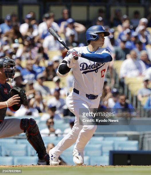 Shohei Ohtani of the Los Angeles Dodgers hits a single in the first inning of a baseball game against the Washington Nationals on April 17 at Dodger...