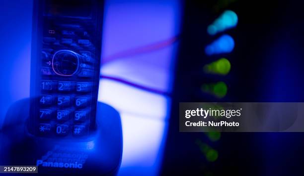 Portable telephone and an internet router modem are seen in this illustration photo in Warsaw, Poland on 17 April, 2024.