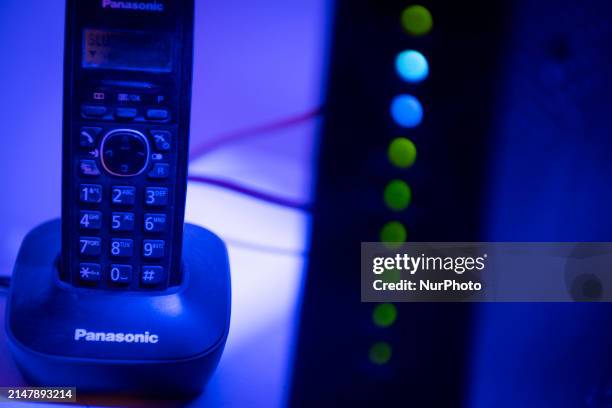 Portable telephone and an internet router modem are seen in this illustration photo in Warsaw, Poland on 17 April, 2024.