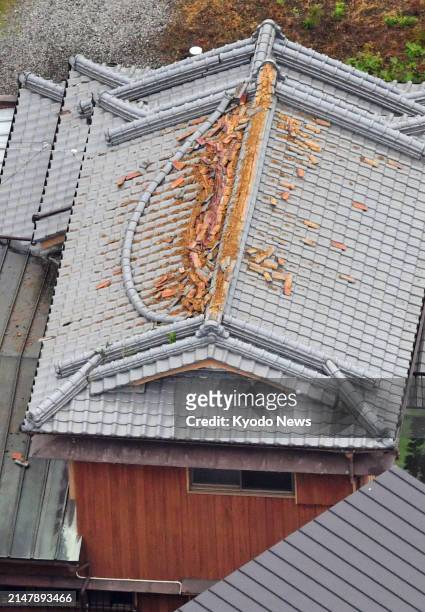 Photo taken from a Kyodo News helicopter shows a damaged rooftop in Sukumo in Kochi Prefecture, western Japan, on April 18 after an earthquake with a...