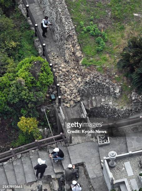 Photo taken from a Kyodo News helicopter shows a partially collapsed stone wall in Ainan in Ehime Prefecture, western Japan, on April 18 after an...