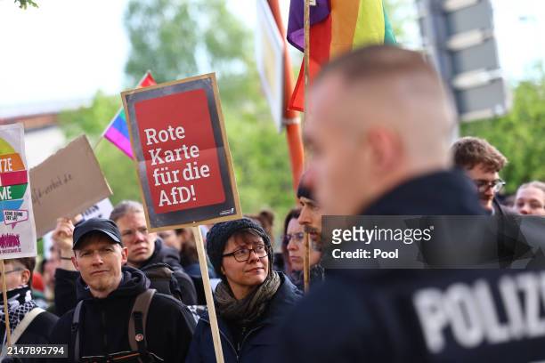 Protesters stand near the courthouse on April 18, 2024 in Halle, Germany. Prosecutors accuse Hoecke of having concluded a political rally in...