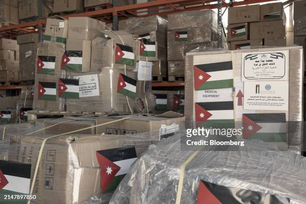 Palestinian flags on packages of humanitarian aid ahead of shipping to the Gaza Strip at a warehouse operated by the Jordan Hashemite Charity...