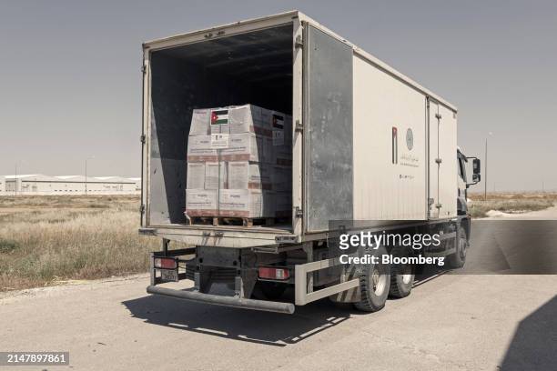Truck is loaded with goods in a warehouse of the Jordan Hashemite Charity Organization during an operation of packing and stocking of aid directed to...