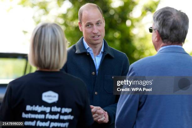 Prince William, Prince of Wales is greeted as he arrives for a visit to Surplus to Supper, in Sunbury-on-Thames on April 18, 2024 in Surrey, England....