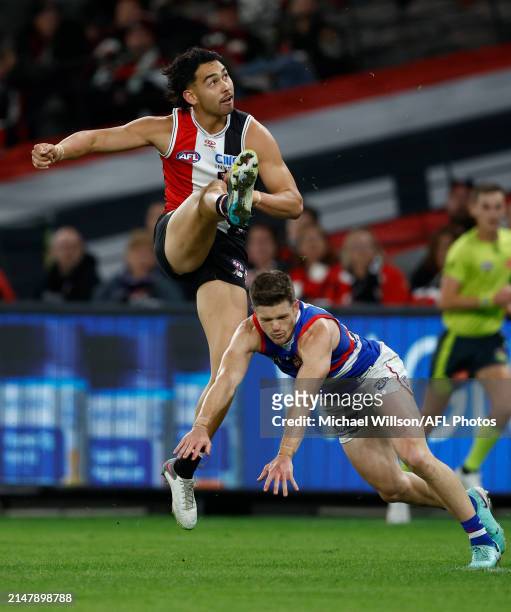 Mitch Owens of the Saints snaps a goal over Taylor Duryea of the Bulldogs during the 2024 AFL Round 06 match between the St Kilda Saints and the...