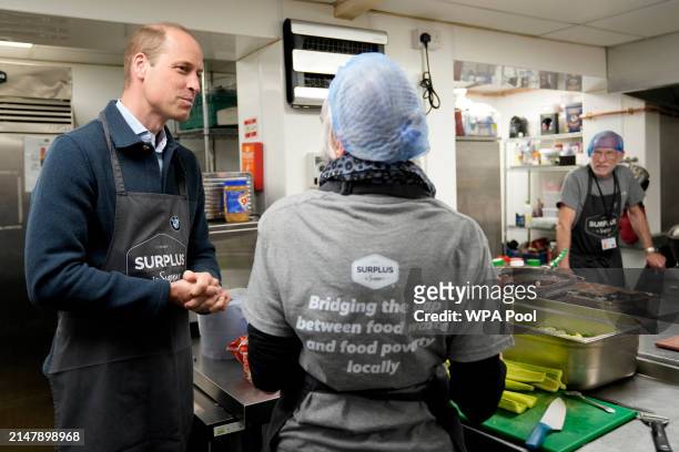 Prince William, Prince of Wales meets workers during a visit to Surplus to Supper, in Sunbury-on-Thames on April 18, 2024 in Surrey, England. The...