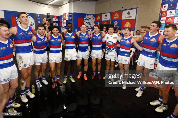Bulldogs players sing the team song during the 2024 AFL Round 06 match between the St Kilda Saints and the Western Bulldogs at Marvel Stadium on...