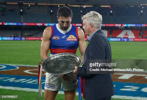 Marcus Bontempelli of the Bulldogs is presented with the Barker-Whitten Challenge Plate by Challenge CEO David Rogers during the 2024 AFL Round 06...