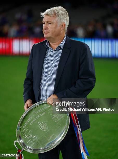 Challenge CEO David Rogers is seen with the Barker-Whitten Challenge Plate during the 2024 AFL Round 06 match between the St Kilda Saints and the...