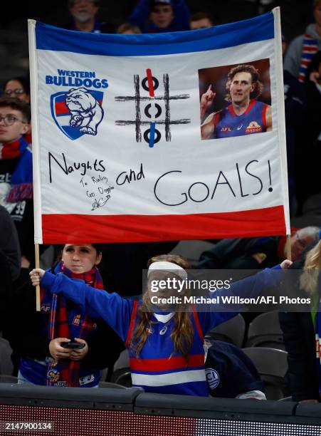 Young Bulldogs fan holds a sign in support of Aaron Naughton during the 2024 AFL Round 06 match between the St Kilda Saints and the Western Bulldogs...