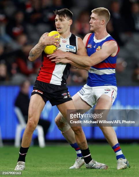 Josh Battle of the Saints and Tim English of the Bulldogs in action during the 2024 AFL Round 06 match between the St Kilda Saints and the Western...