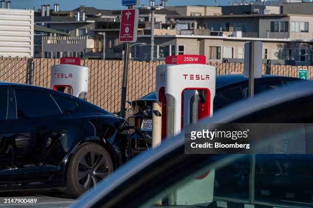 Tesla vehicle at a supercharging station in San Francisco, California, US, on Wednesday, April 17, 2024. Tesla Inc. Is slashing headcount by more...