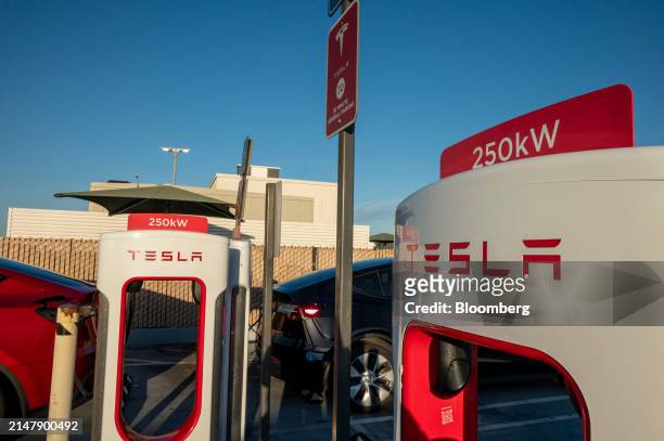 Tesla supercharging stations in San Francisco, California, US, on Wednesday, April 17, 2024. Tesla Inc. Is slashing headcount by more than 10%, part...