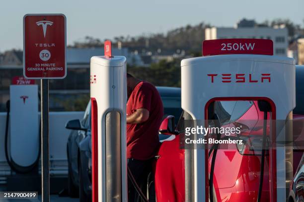 Tesla vehicles at supercharging stations in San Francisco, California, US, on Wednesday, April 17, 2024. Tesla Inc. Is slashing headcount by more...
