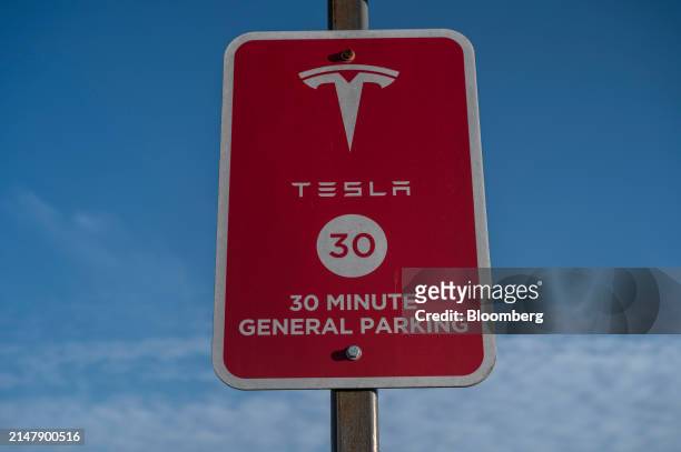 Tesla supercharging station sign in San Francisco, California, US, on Wednesday, April 17, 2024. Tesla Inc. Is slashing headcount by more than 10%,...