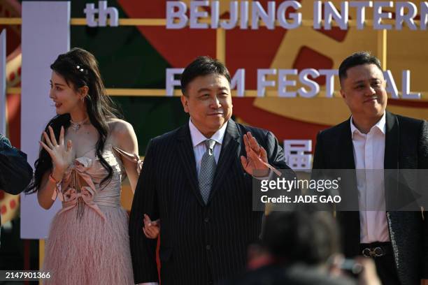 Hong Kong filmmaker Wong Jing arrives on the red carpet during the opening ceremony of the 14th Beijing International Film Festival in Beijing, on...
