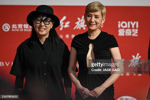 Hong Kong actress Sandra Ng arrives on the red carpet during the opening ceremony of the 14th Beijing International Film Festival in Beijing, on...
