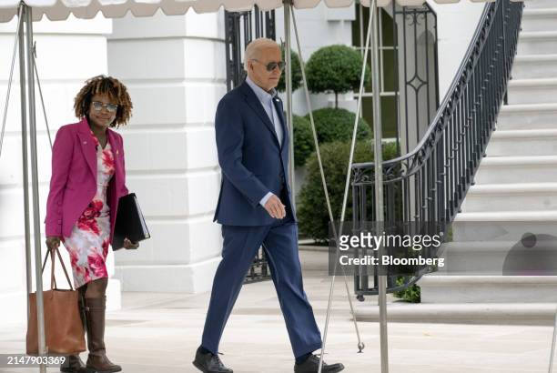 Karine Jean-Pierre, White House press secretary, left, and US President Joe Biden walk on the South Lawn of the White House before boarding Marine...