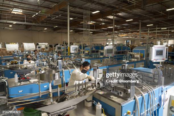 Employees work on the pultrusion process of joining carbon fibers at the TS Conductor Corp. Production facility in Huntington Beach, California, US,...
