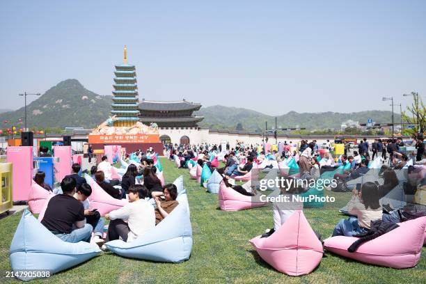 Citizens are enjoying reading at Gwanghwamun Square in Seoul, South Korea, on April 18 during the first day of the Gwanghwamun Book Plaza operation....