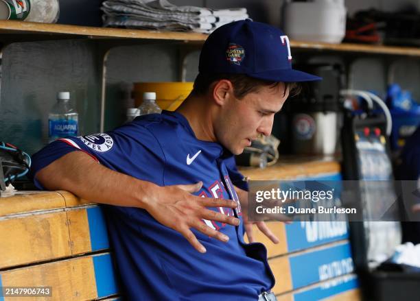 Jack Leiter of the Texas Rangers sits in the dugout after being pulled during the fourth inning of a game in his MLB Debut against the Detroit Tigers...