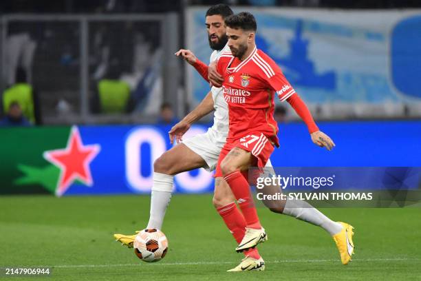 Marseille's French defender Samuel Gigot fights for the ball with Benfica's Portuguese midfielder Rafa Silva during the UEFA Europa League quarter...