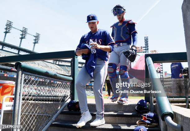 Starting pitcher Jack Leiter of the Texas Rangers enters at the dugout with catcher Jonah Heim before the start of Leiter's MLB Debut against the...