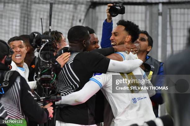 Marseille's Cameroonian forward Faris Moumbagna celebrates scoring his team's first goal with teammates during the UEFA Europa League quarter final...