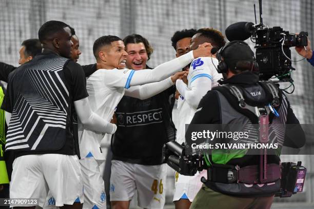 Marseille's Cameroonian forward Faris Moumbagna celebrates scoring his team's first goal with teammates during the UEFA Europa League quarter final...