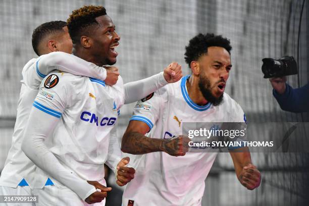 Marseille's Cameroonian forward Faris Moumbagna celebrates scoring his team's first goal with Marseille's French-Gabonese forward Pierre-Emerick...