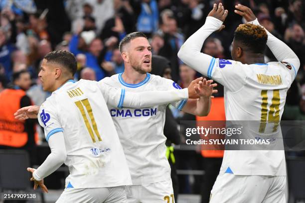 Marseille's Cameroonian forward Faris Moumbagna celebrates scoring his team's first goal with Marseille's Moroccan French midfielder Amine Harit and...