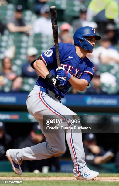 Corey Seager of the Texas Rangers hits into a fielders choice that allows Leody Taveras to score against the Detroit Tigers and take a 8-7 lead...