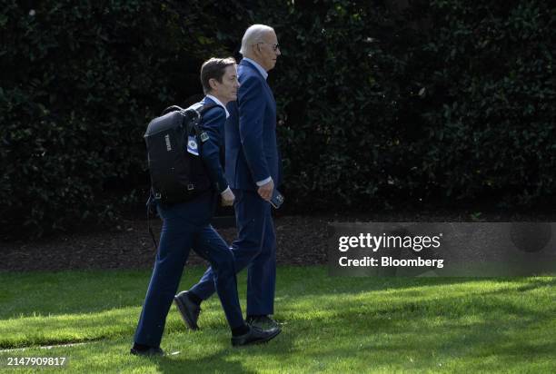 President Joe Biden, right, and Bruce Reed, White House deputy chief of staff , walk on the South Lawn of the White House after arriving on Marine...