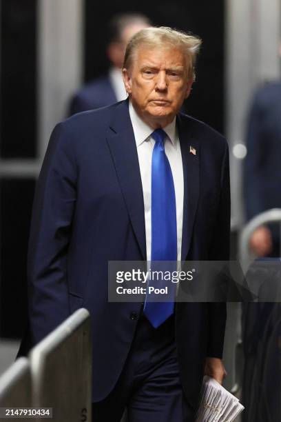 Former US President Donald Trump walks to speak to the media as he leaves court for the day at Manhattan Criminal Court on April 18, 2024 in New York...