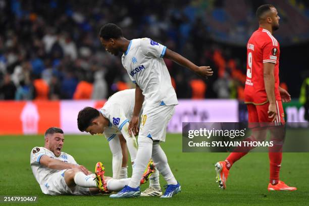 Marseille's French midfielder Jordan Veretout reacts as he lays on the pitch during the UEFA Europa League quarter final second leg football match...