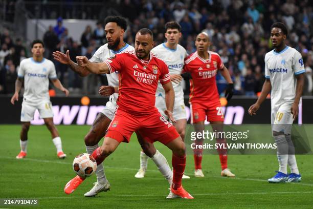 Marseille's French-Gabonese forward Pierre-Emerick Aubameyang fights for the ball with Benfica's Brazilian striker Arthur Cabral during the UEFA...
